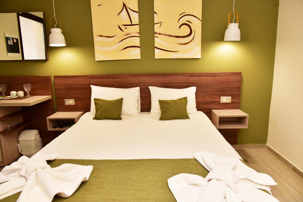 a bedroom with a large bed with towels on it at Lafo Rooms in Elafonisi