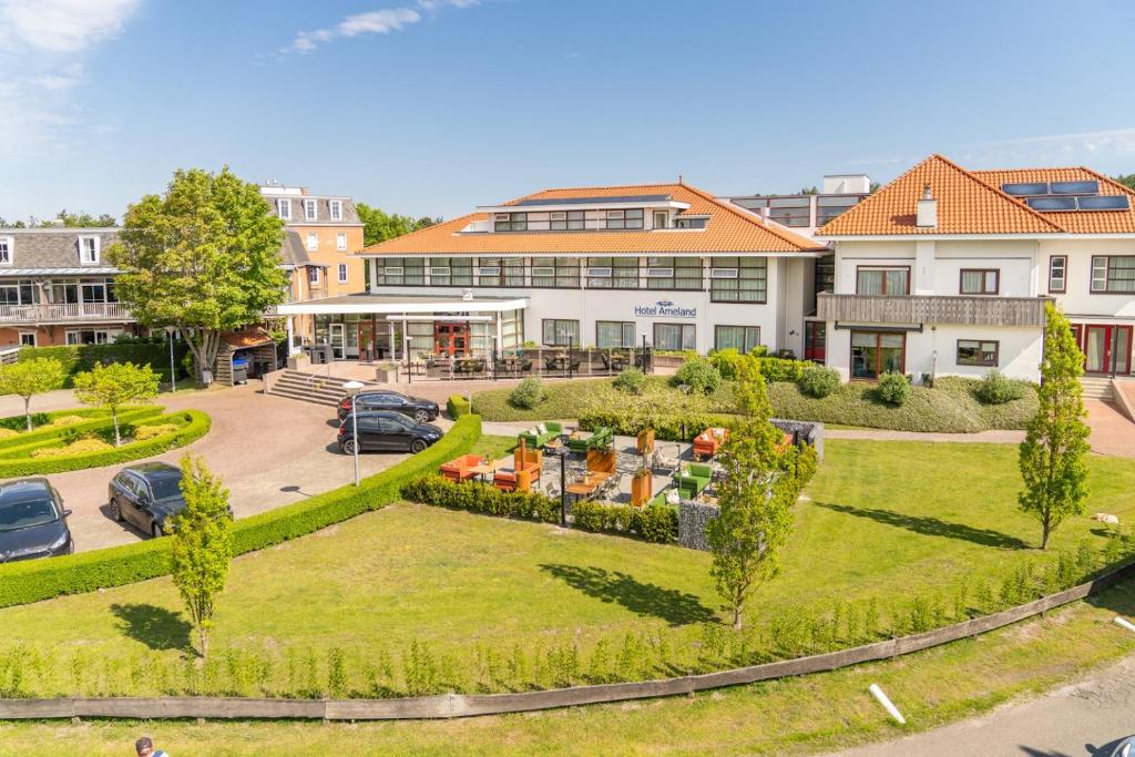 an aerial view of a park in front of a building at Hotel Ameland in Nes