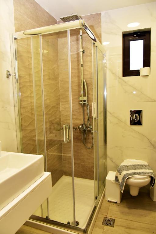 a bathroom with a shower and a sink at Lafo Rooms in Elafonisi