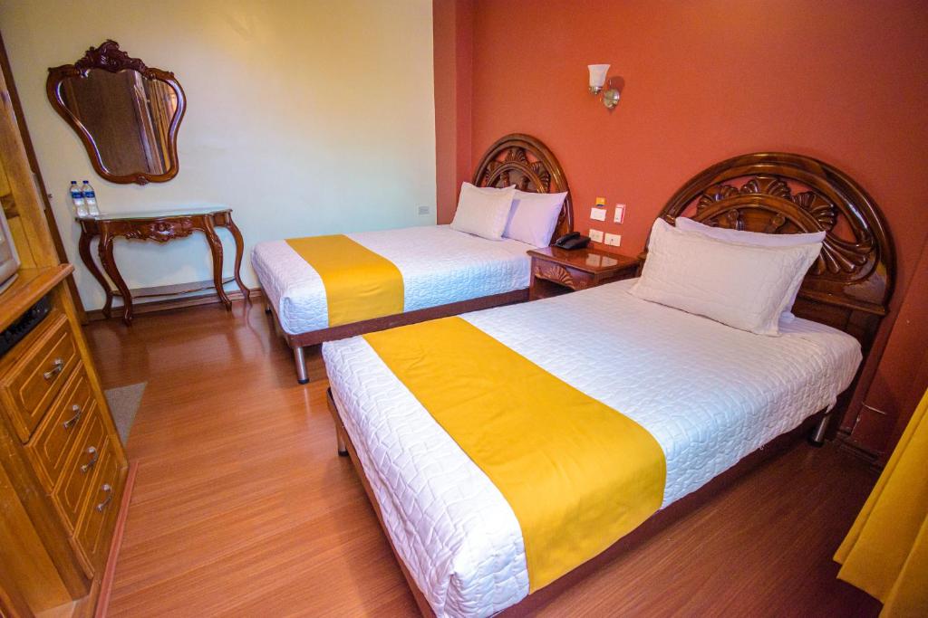 Postel nebo postele na pokoji v ubytování Hotel Cumbayá Sanvy