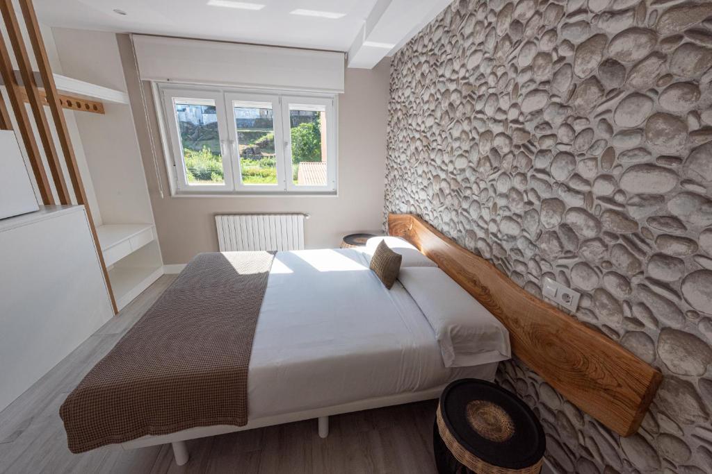Postel nebo postele na pokoji v ubytování APARTAMENTOS CUME DO PINDO