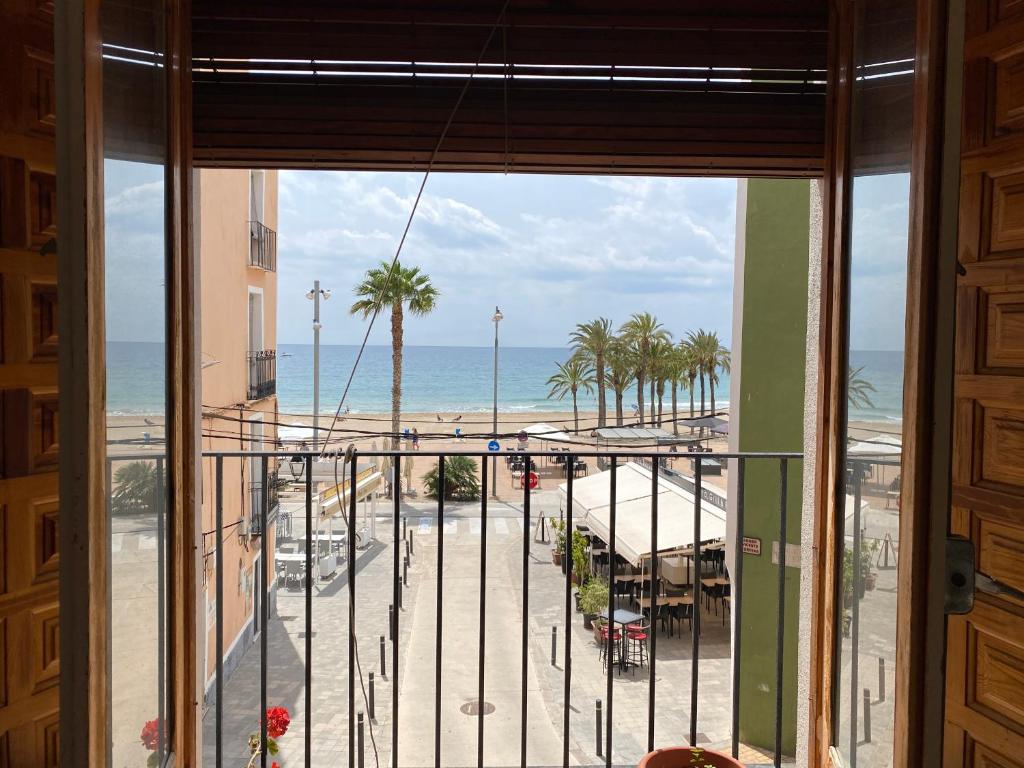 a balcony with a view of the beach and the ocean at Apartamento In Front Of The Beach Primera Linea De Playa in Villajoyosa