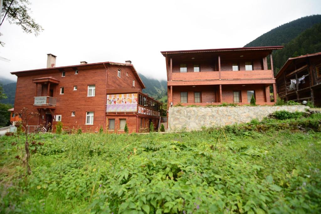 two buildings on top of a grassy hill at Uzungol Apart in Uzungol