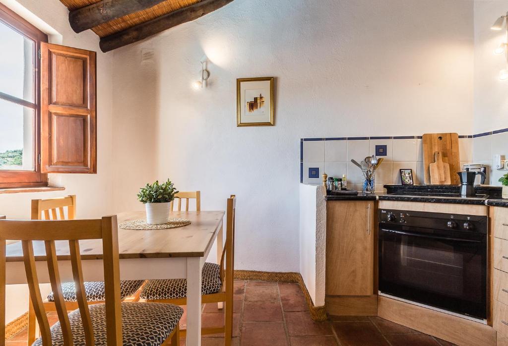 A kitchen or kitchenette at Casa Sol - traditional village house with pool and view