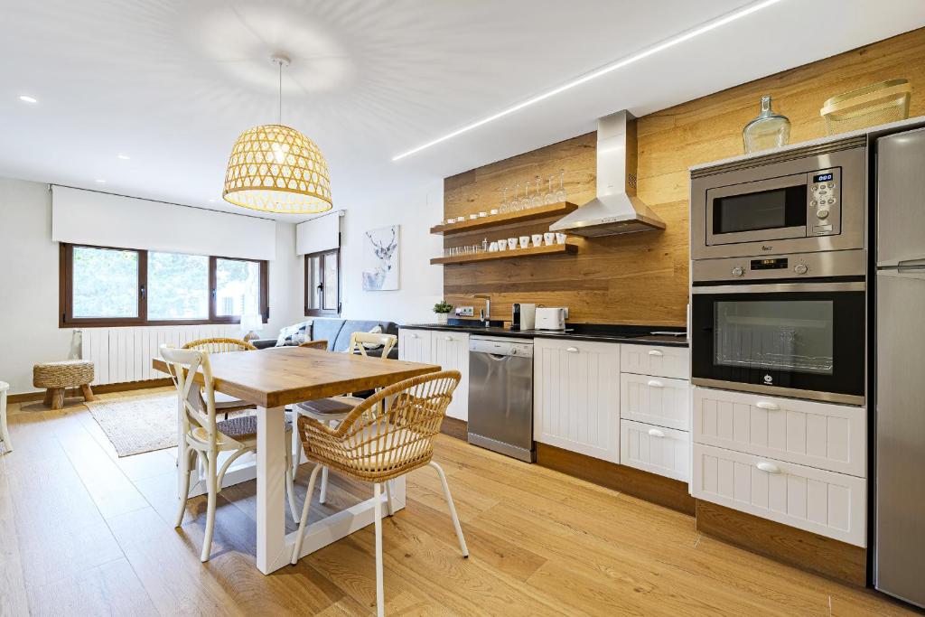 a kitchen with a table and a dining room at Casa Paredes, Bronchales in Bronchales