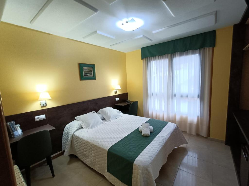 Voodi või voodid majutusasutuse Hotel Casa Benilde toas