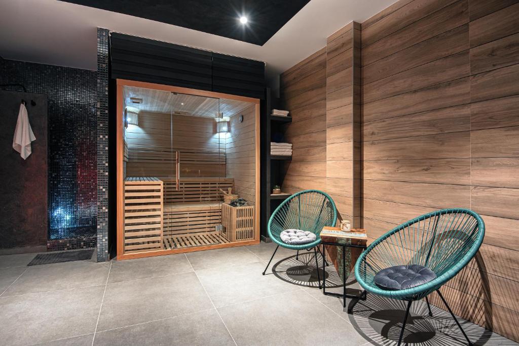 a room with two chairs and a wooden wall at Exclusive City Apartments in Pula