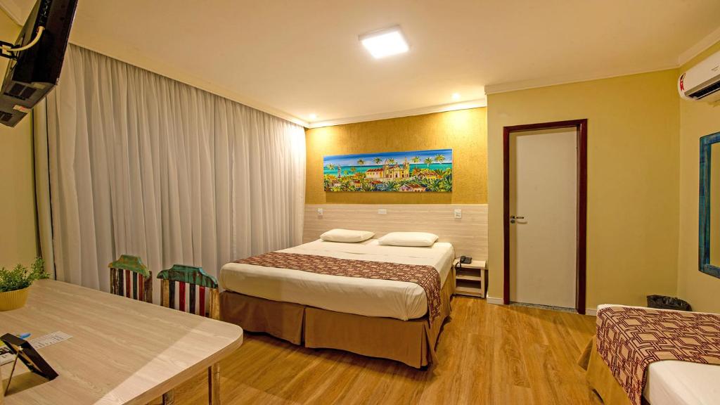 Cama ou camas em um quarto em Hotel Costeiro