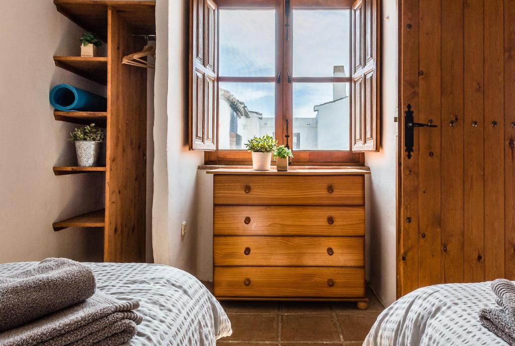 A bed or beds in a room at Casa Sol - traditional village house with pool and view