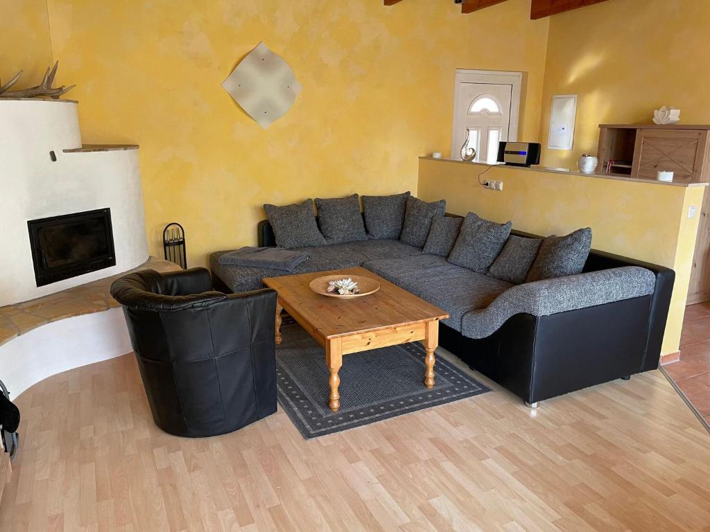 a living room with a couch and a coffee table at Gemütlicher Bungalow am Meer in Pepelow in Pepelow