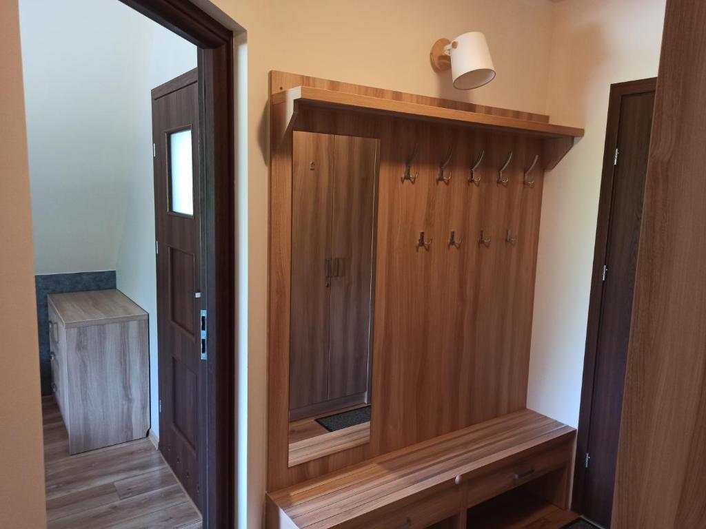 a bathroom with a wooden cabinet with a mirror at Willa Zielona Polana in Czarna Góra