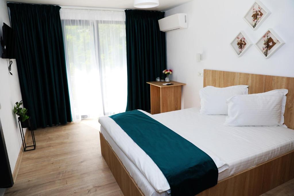 Postel nebo postele na pokoji v ubytování Hotel Dunavis