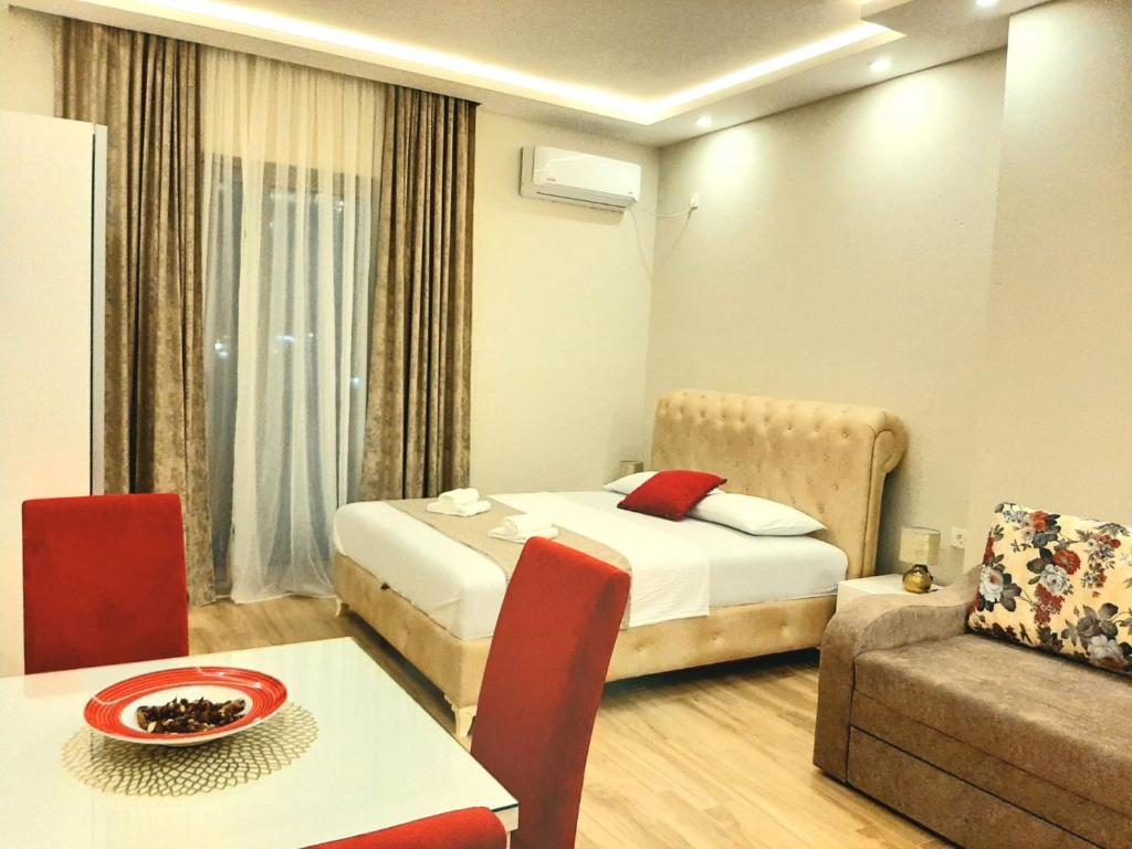 a hotel room with a bed and a table and a couch at Apolon Apart in Bar, Susanj