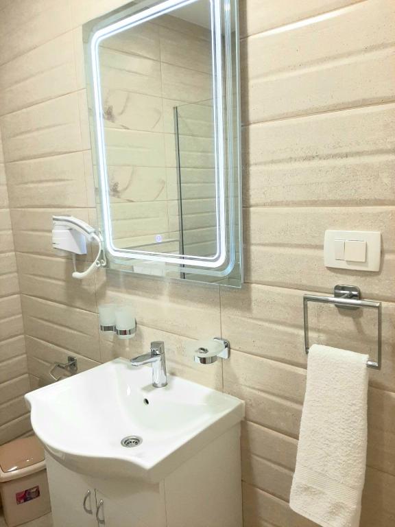 a bathroom with a sink and a mirror at Apolon Apart in Bar, Susanj