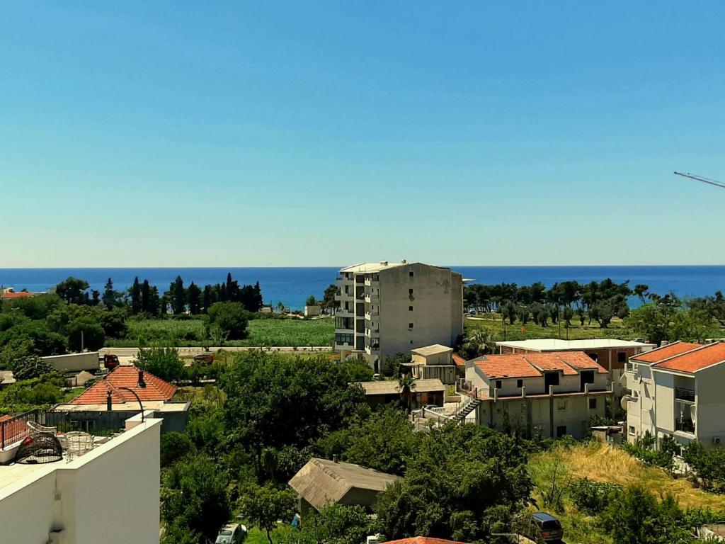 a city with buildings and the ocean in the background at Apolon Apart in Bar, Susanj