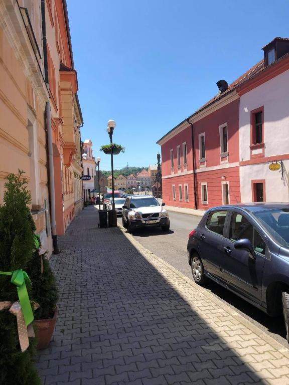 a street with cars parked on the side of the road at Apartmány u sv. Michaela in Kadaň