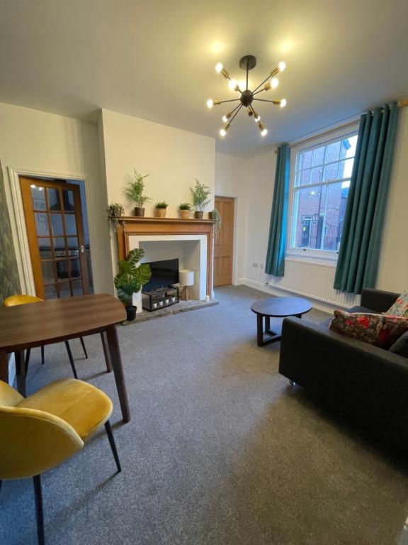 a living room with a couch and a fireplace at BOUTIQUE CITY CENTRE APARTMENT WITH PARKING in Chester