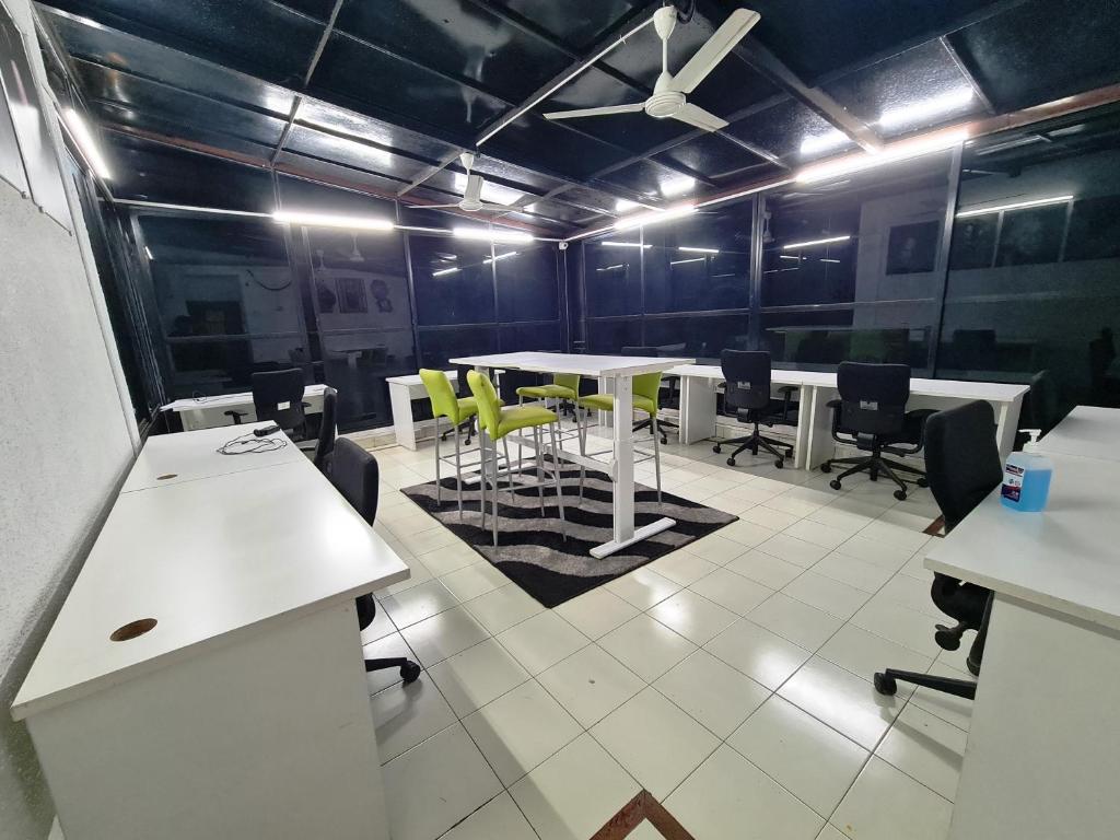 an office with a table and chairs in a room at Hostel Lifespace- Twin Bungalow with Pods, Bunks, Private Rooms, CoWork & Cafe in Pune