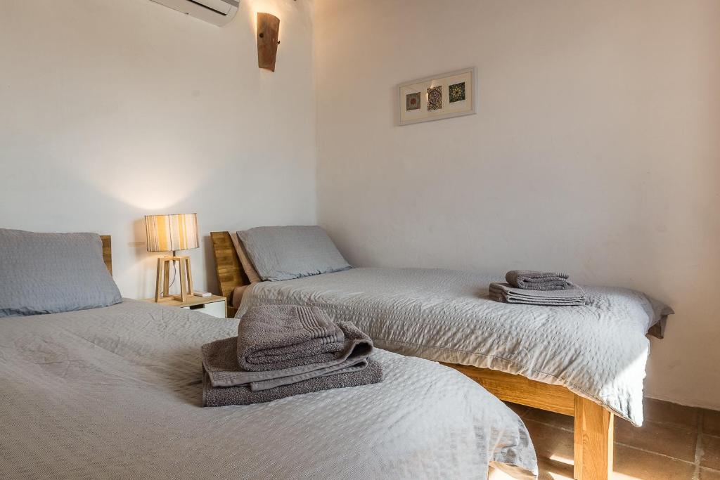 A bed or beds in a room at Casa Sol - traditional village house with pool and view