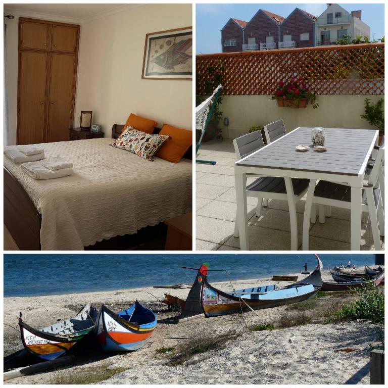 a room with a bed and a table with a boat on the ground at Verde Ria apartamento in Torreira