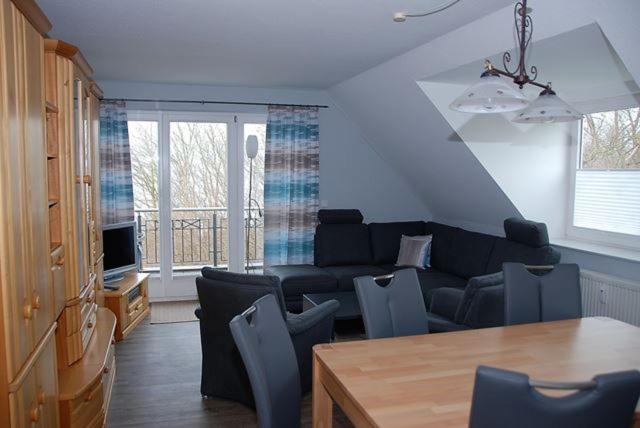 a living room with a couch and a table at Seesternchen in Am Schwarzen Busch