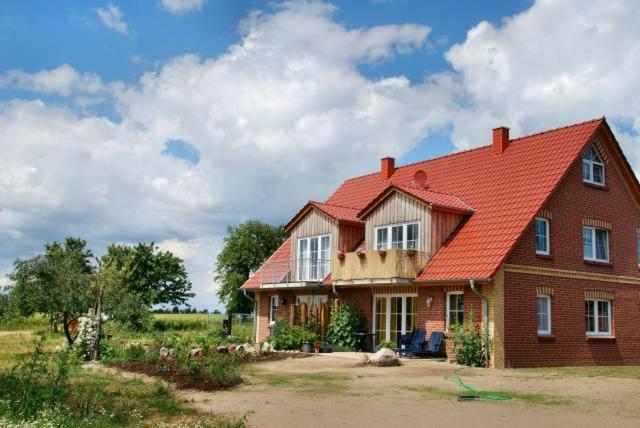 a large brick house with a red roof at Andrea in Timmendorf