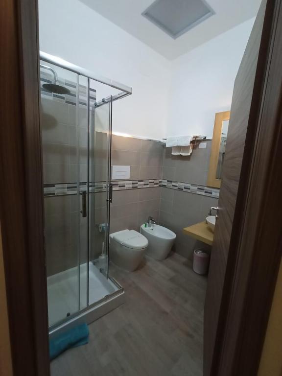 a bathroom with a glass shower and a toilet at Sweet Dreams in San Vito lo Capo