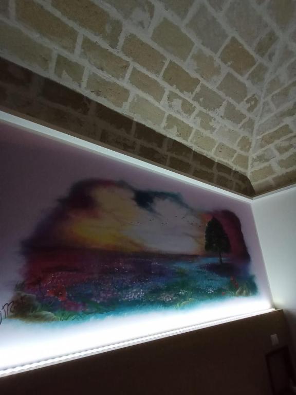 a shelf in a refrigerator with a painting on it at Sweet Dreams in San Vito lo Capo