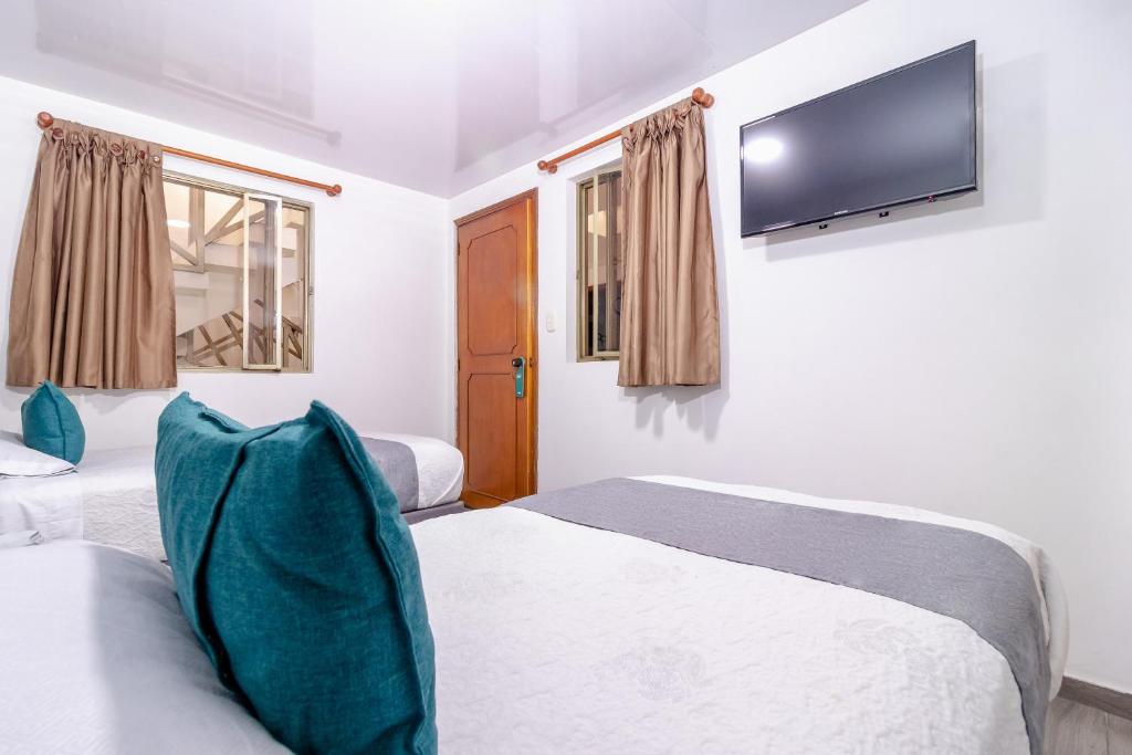Postel nebo postele na pokoji v ubytování Ayenda Hotel Las Palmas