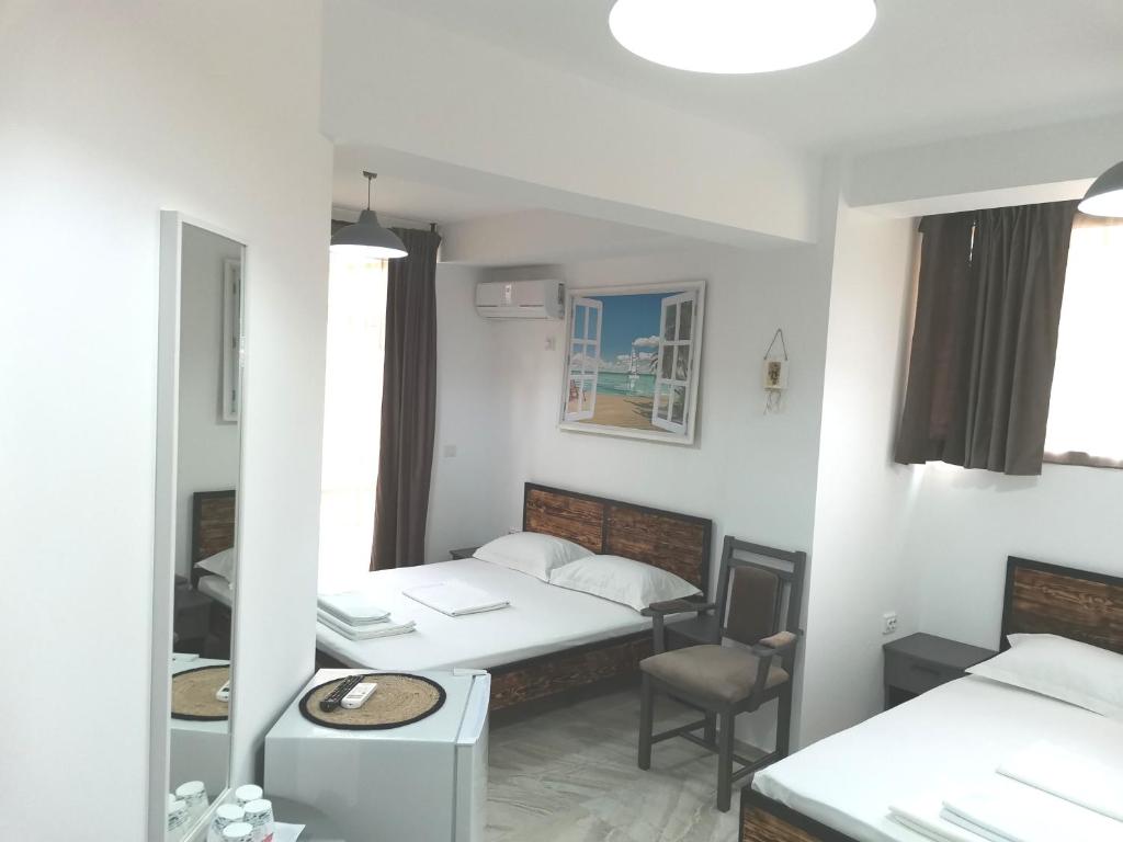 a small room with a bed and a chair at Casa George Mamaia Nord in Mamaia Nord