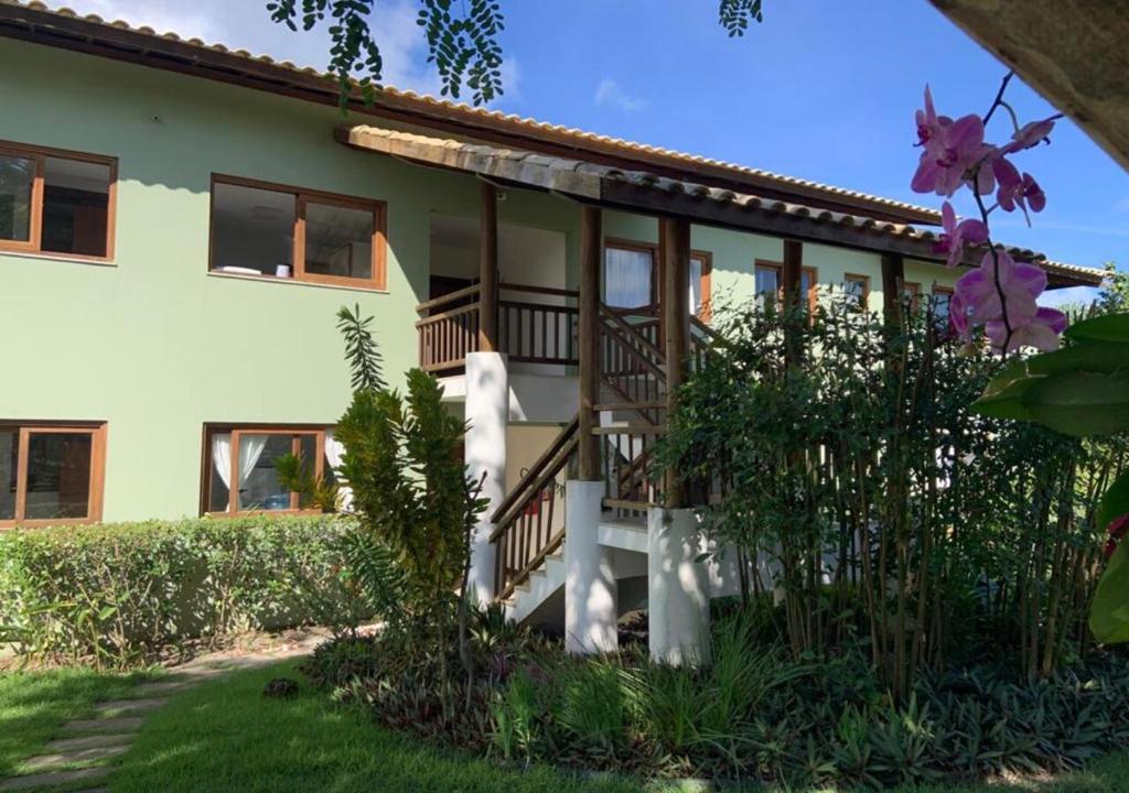 a house with a staircase in front of it at Apartamento Reserva Imbassai - Terraco Buganvilias in Imbassai