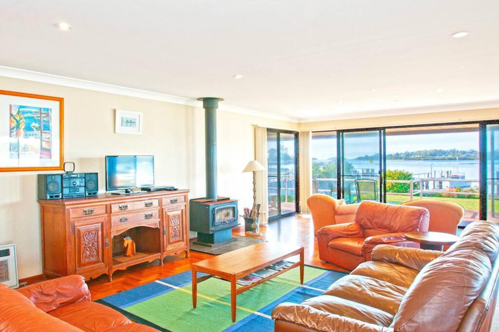 a living room with a couch and a fireplace at HAIS18G - Riverside Delight in Greenwell Point