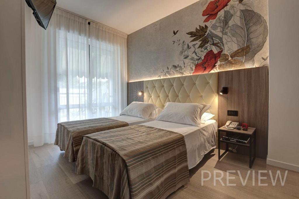 Postel nebo postele na pokoji v ubytování Hotel Picobello Pineta