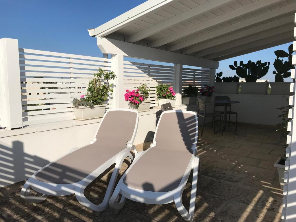 a pair of chairs sitting on a patio at Innsud in Nardò