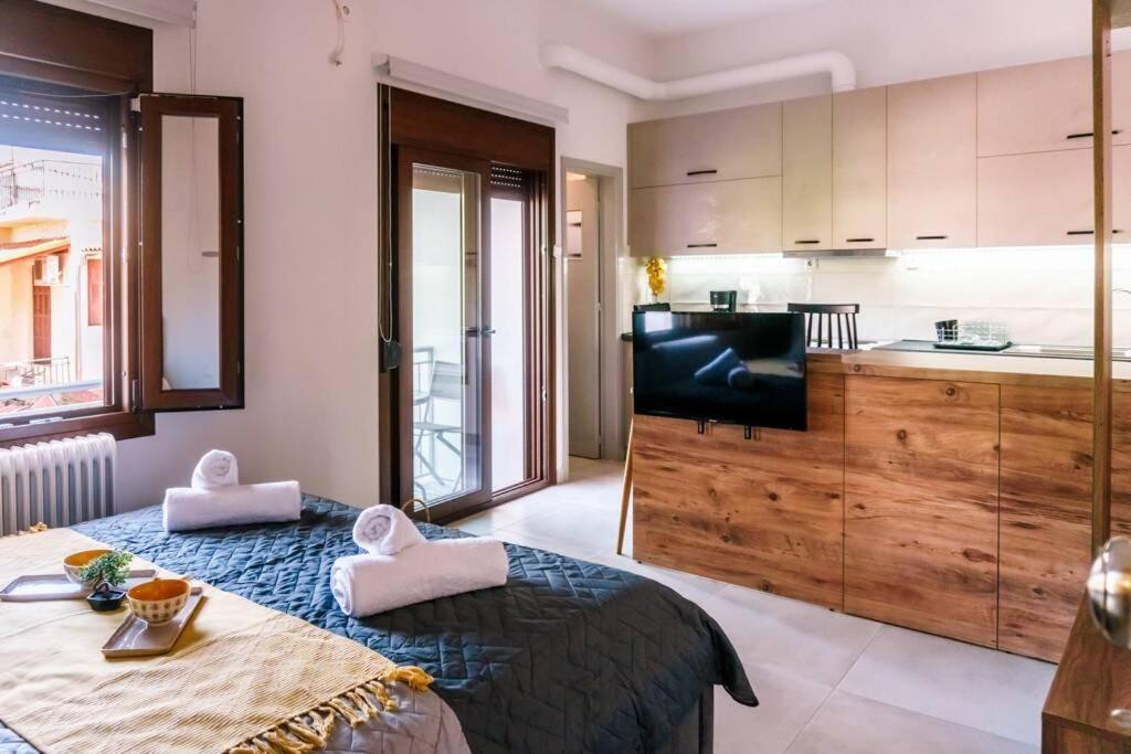 a room with a bed and a television and a kitchen at Kala Nera seaside bnb in Kala Nera