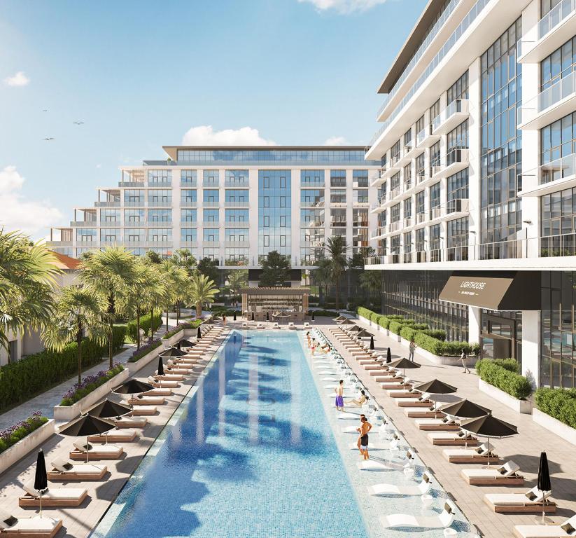 an rendering of a resort pool with lounge chairs and a building at Sea Breeze in Baku