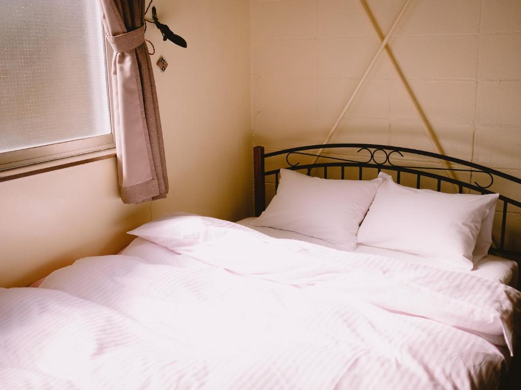 Postel nebo postele na pokoji v ubytování Guesthouse Hitoyado