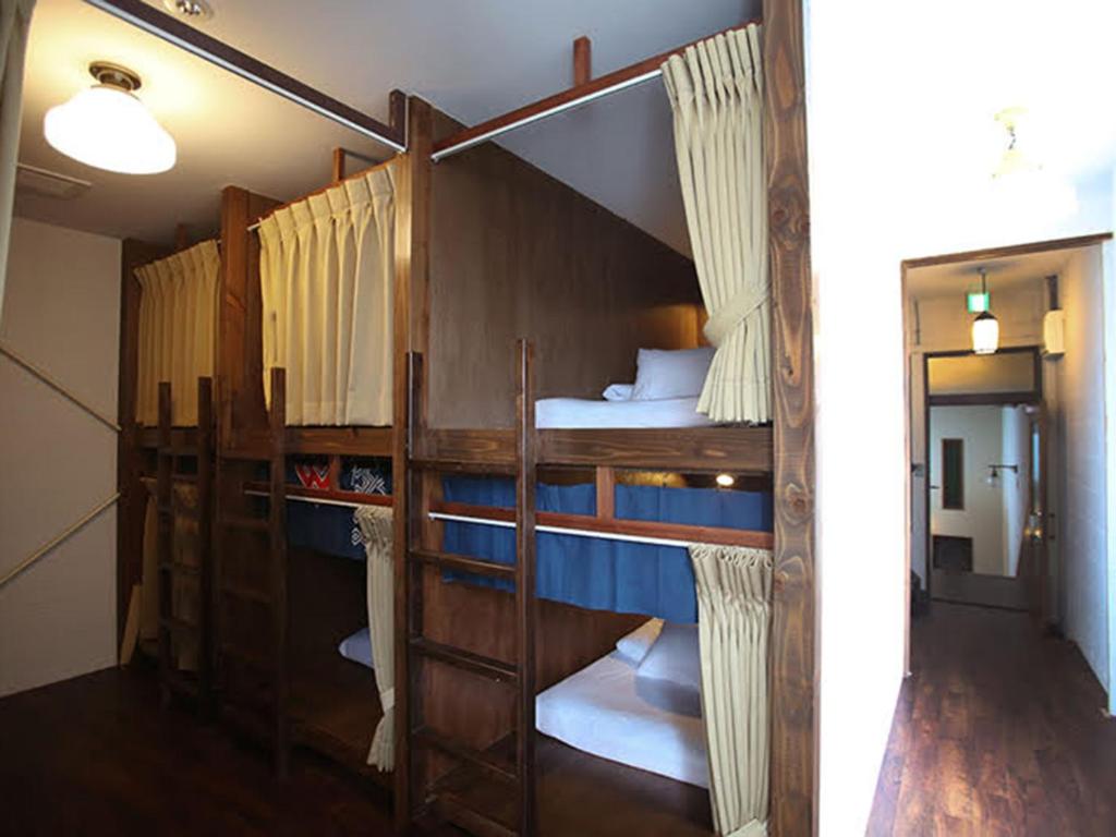 Postel nebo postele na pokoji v ubytování Guesthouse Hitoyado