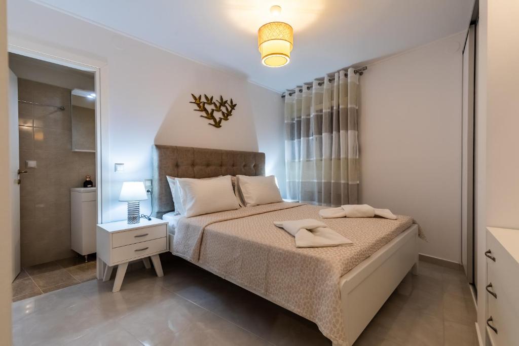 Postel nebo postele na pokoji v ubytování Nevila House