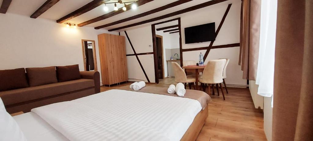a room with a bed and a couch and a table at Lindenhaus in Sibiu