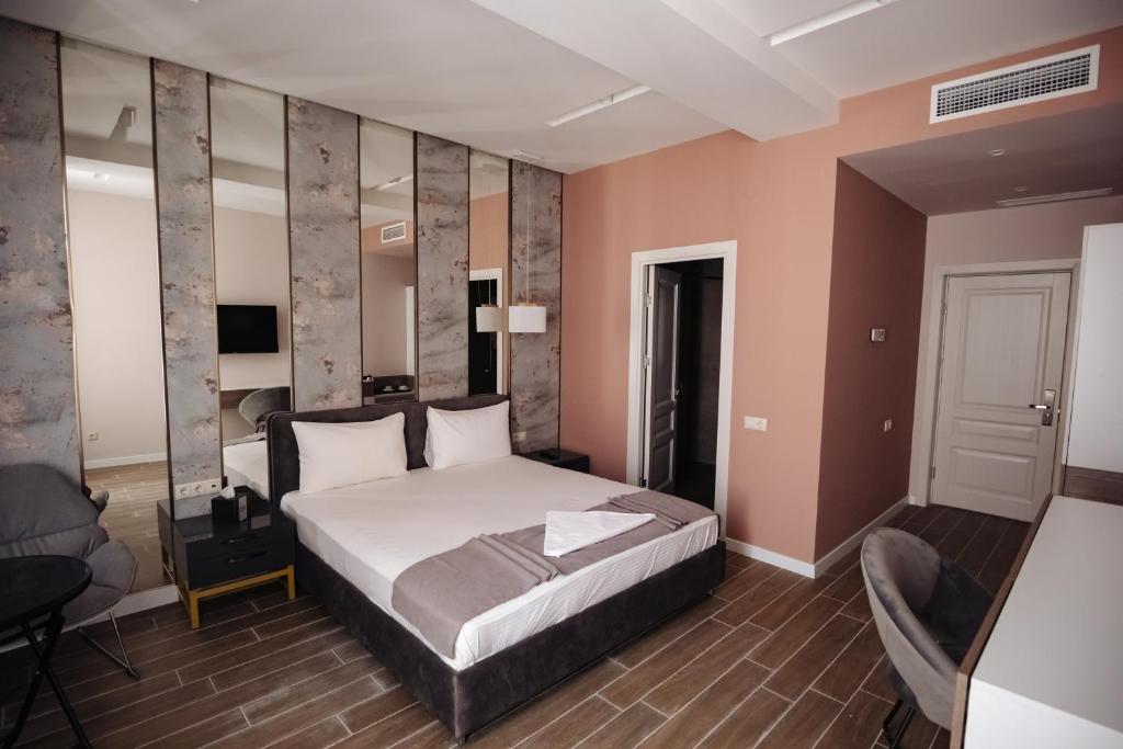 a bedroom with a bed and a chair in a room at GS Premium in Yerevan