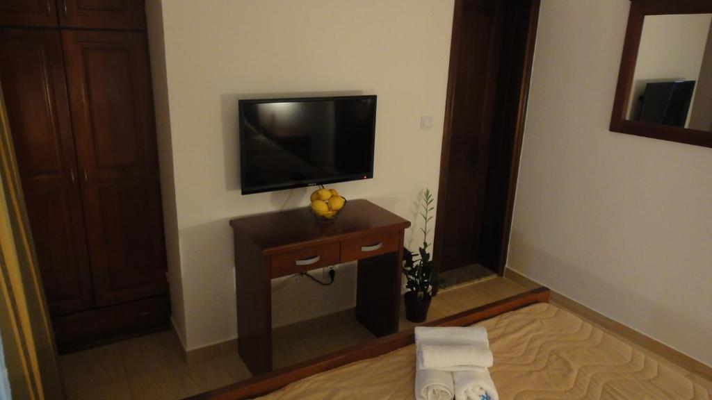 a room with a television on a wall at Apartmani More in Sveti Stefan