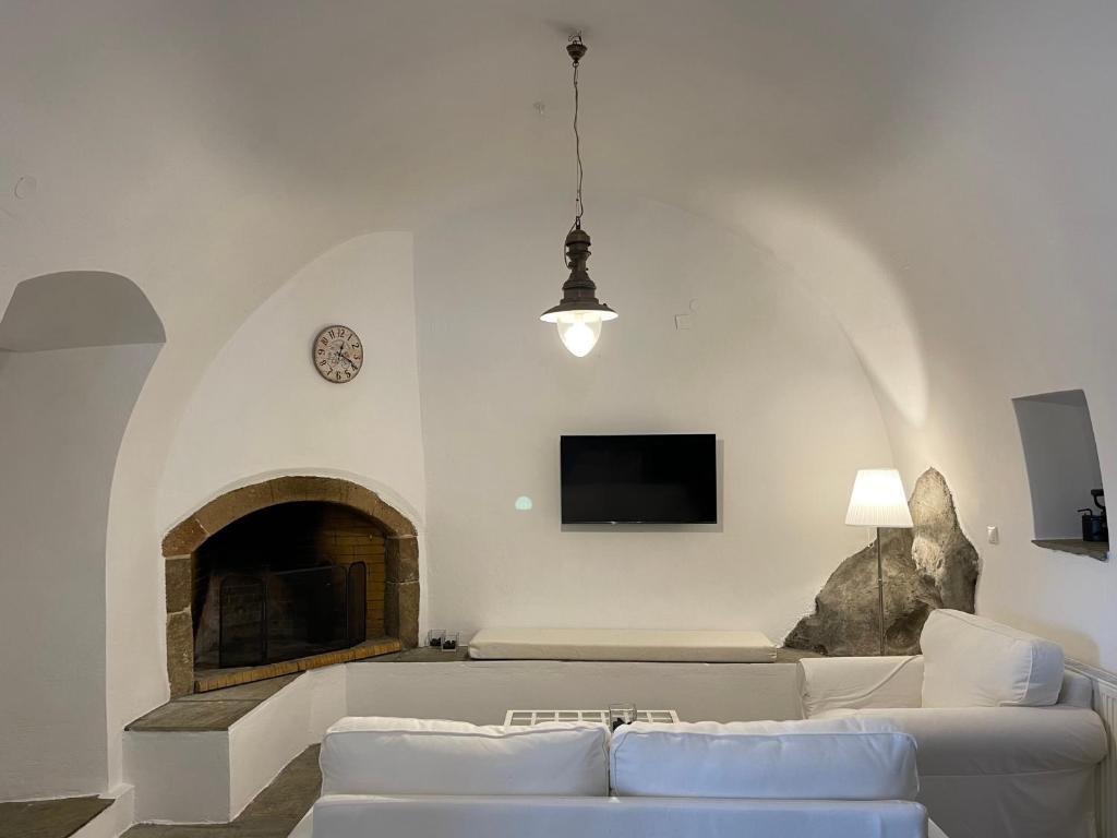 a living room with a couch and a fireplace at Drymonas Heights Kythira Traditional Volto in Kýthira