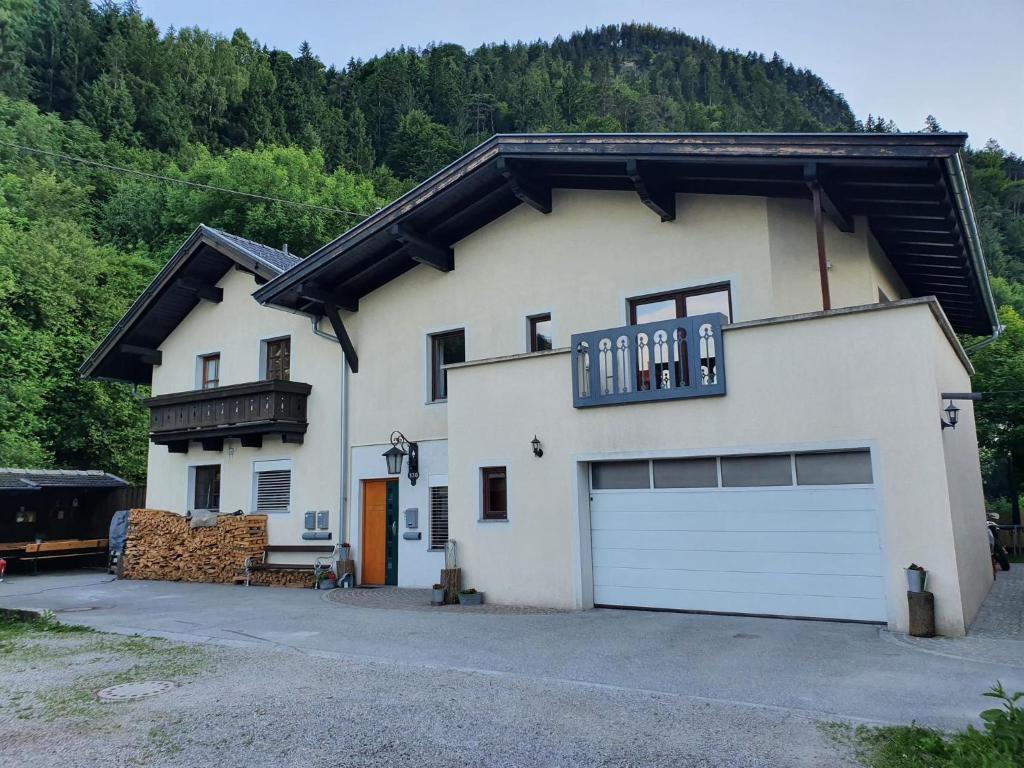 a large white house with a garage at Schlossbergblick in Radfeld