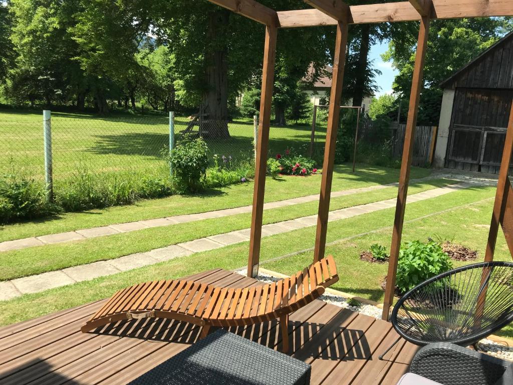 a wooden bench sitting on a wooden deck at Privat in Liptovský Ján