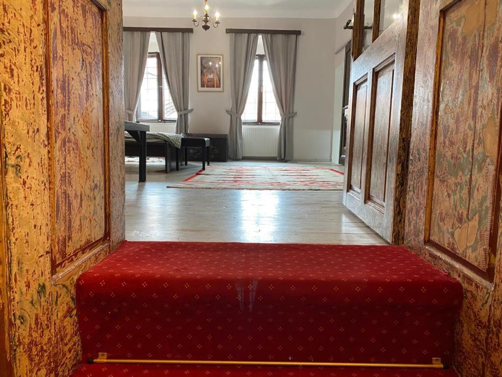 a red bench sitting in the middle of a room at Casa Poetului in Sibiu