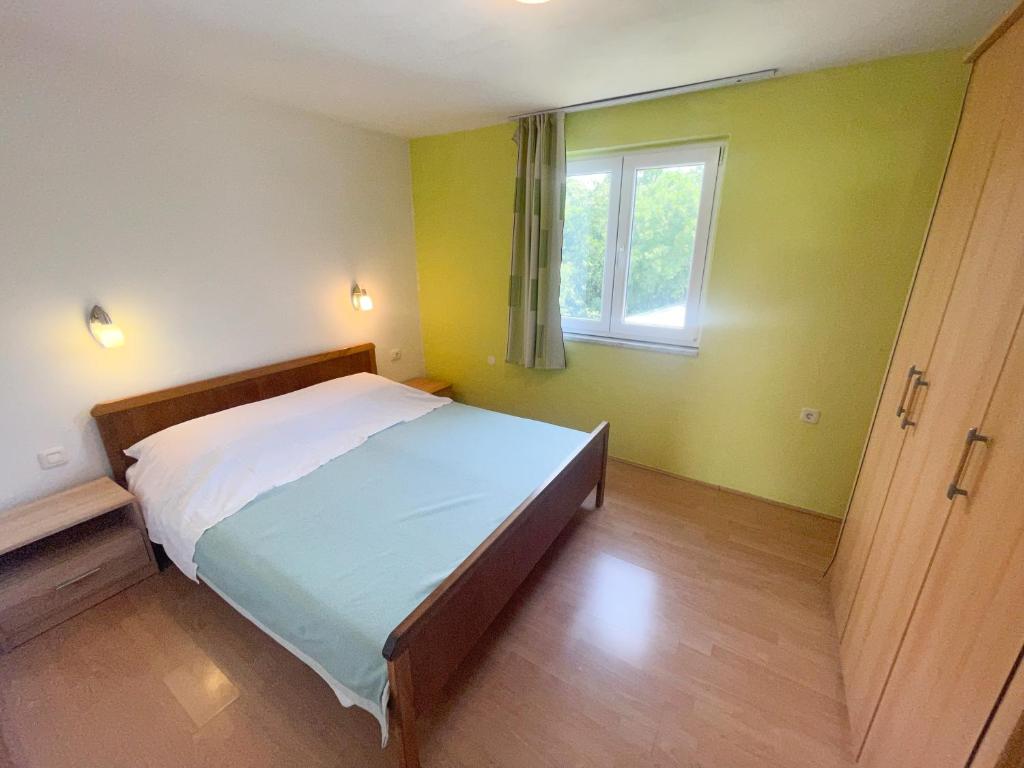 Postel nebo postele na pokoji v ubytování Apartmani Matković