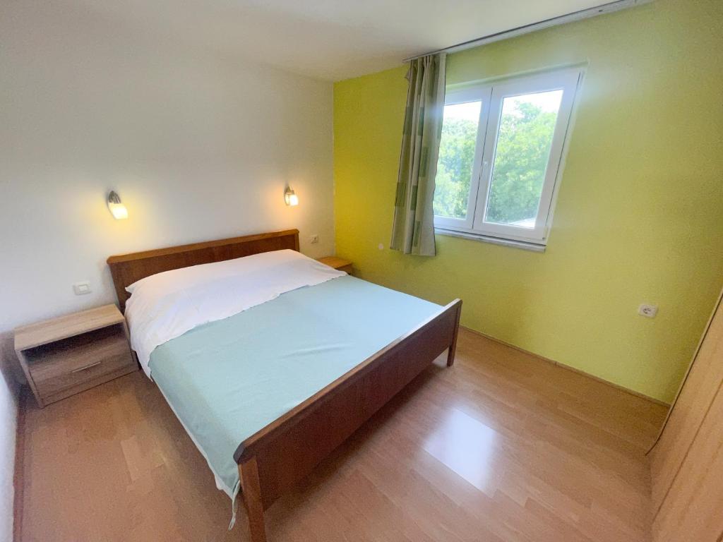 Postel nebo postele na pokoji v ubytování Apartmani Matković