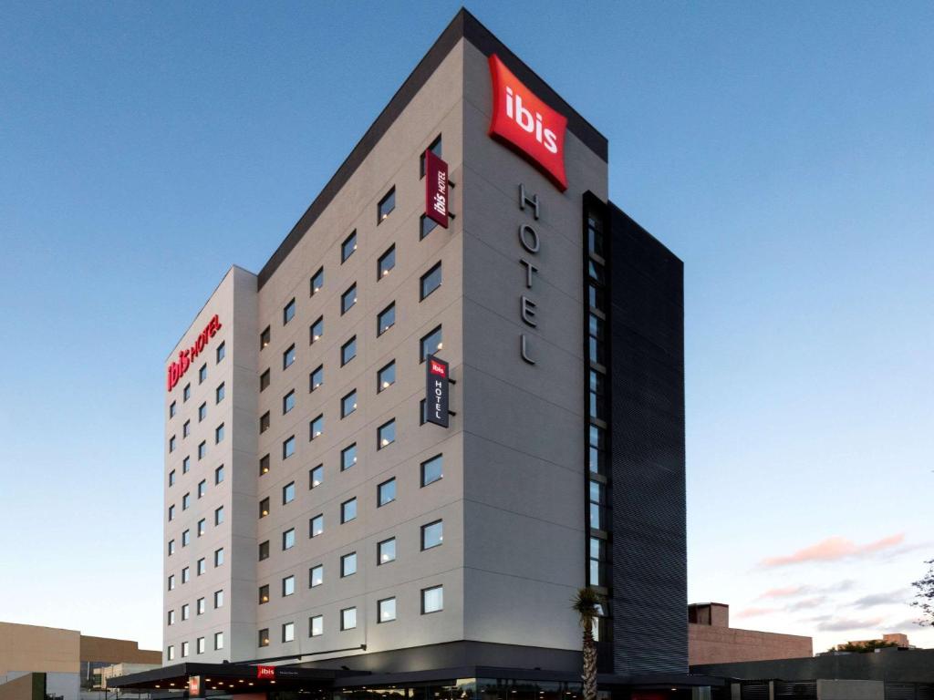a hotel building with a sign on the side of it at ibis Tijuana in Tijuana