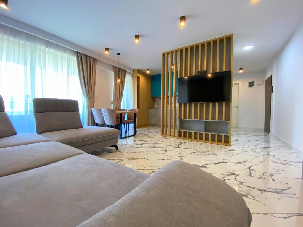 a living room with a couch and a flat screen tv at North Star Apartment 15 in Timişoara